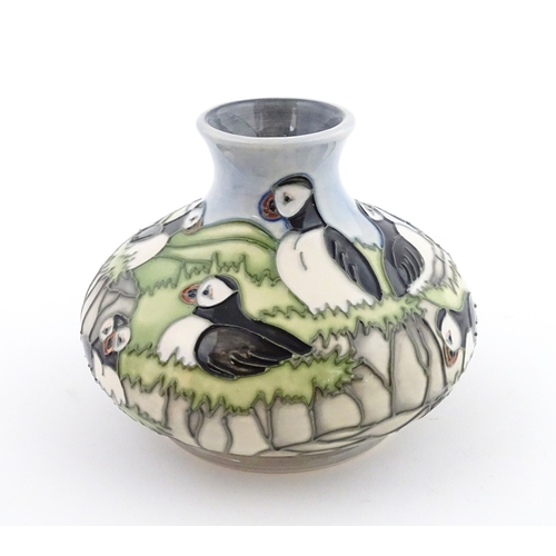 103 - A Moorcroft vase decorated in the Puffin pattern. Marked under. Approx. 4 1/4