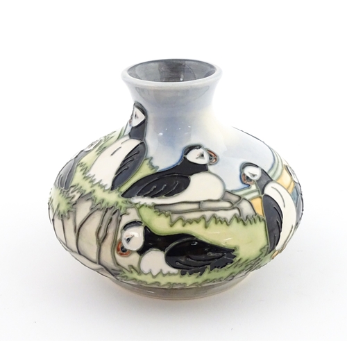 103 - A Moorcroft vase decorated in the Puffin pattern. Marked under. Approx. 4 1/4