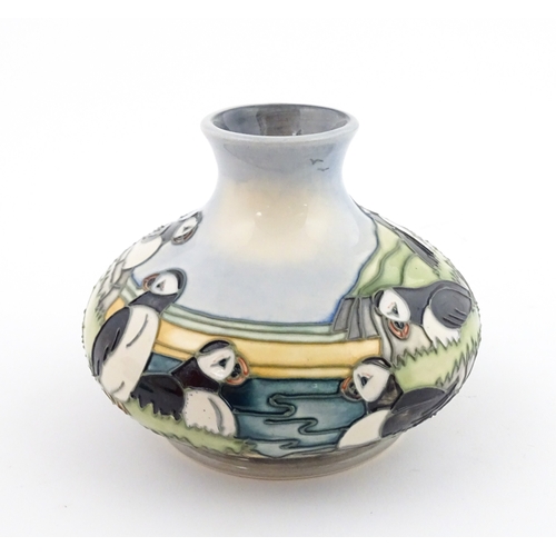 103 - A Moorcroft vase decorated in the Puffin pattern. Marked under. Approx. 4 1/4