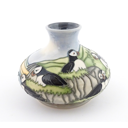 103 - A Moorcroft vase decorated in the Puffin pattern. Marked under. Approx. 4 1/4