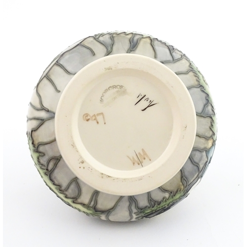 103 - A Moorcroft vase decorated in the Puffin pattern. Marked under. Approx. 4 1/4