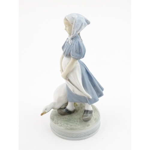 61 - A Royal Copenhagen model Girl with Goose, model no. 527. Marked under. Approx. 9