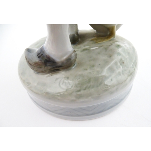 61 - A Royal Copenhagen model Girl with Goose, model no. 527. Marked under. Approx. 9