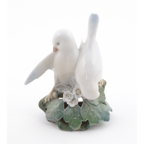 63 - Two Royal Copenhagen models comprising Girl with Doll no. 3539, and Lovebirds no. 402. Marked under.... 