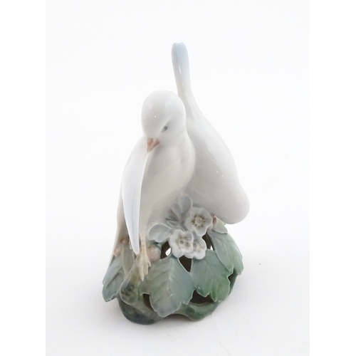 63 - Two Royal Copenhagen models comprising Girl with Doll no. 3539, and Lovebirds no. 402. Marked under.... 