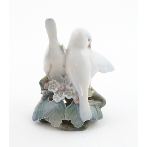 63 - Two Royal Copenhagen models comprising Girl with Doll no. 3539, and Lovebirds no. 402. Marked under.... 