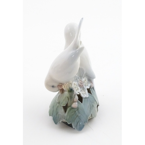 63 - Two Royal Copenhagen models comprising Girl with Doll no. 3539, and Lovebirds no. 402. Marked under.... 