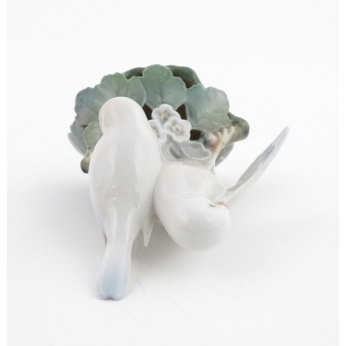 63 - Two Royal Copenhagen models comprising Girl with Doll no. 3539, and Lovebirds no. 402. Marked under.... 