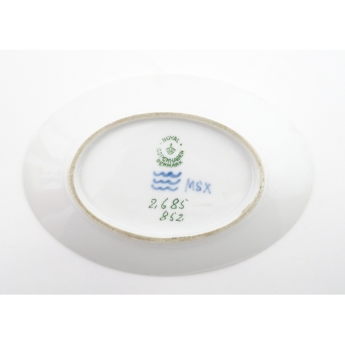 64 - A Royal Copenhagen dish with snowdrop detail, model no. 2685 / 852. Together with a small Kobenhavn ... 