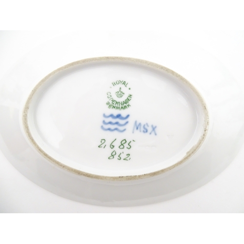 64 - A Royal Copenhagen dish with snowdrop detail, model no. 2685 / 852. Together with a small Kobenhavn ... 