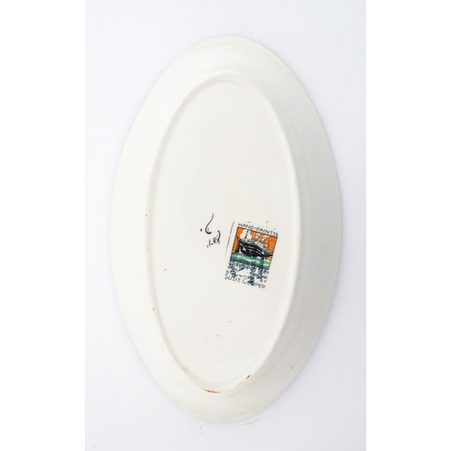 84 - A Susie Cooper dish of oval form with Cubist style decoration, pattern no. 8071. Approx. 8 1/2