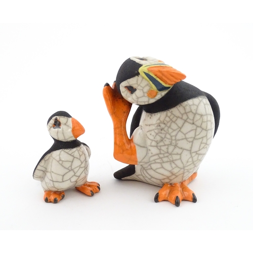 88 - Four studio pottery models of puffins, to include two raku examples by Chloe Harford. Largest approx... 