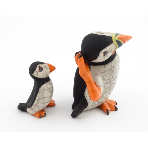 88 - Four studio pottery models of puffins, to include two raku examples by Chloe Harford. Largest approx... 