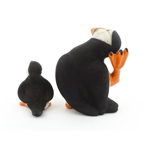 88 - Four studio pottery models of puffins, to include two raku examples by Chloe Harford. Largest approx... 