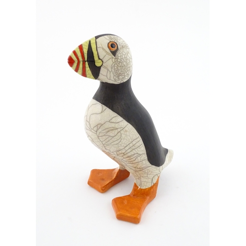 90 - A studio pottery raku fired model of a puffin by Tony White. Marked under. Approx. 9 3/4