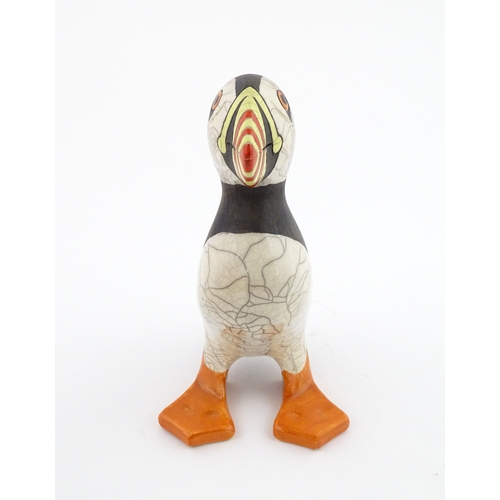 90 - A studio pottery raku fired model of a puffin by Tony White. Marked under. Approx. 9 3/4