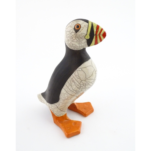 90 - A studio pottery raku fired model of a puffin by Tony White. Marked under. Approx. 9 3/4