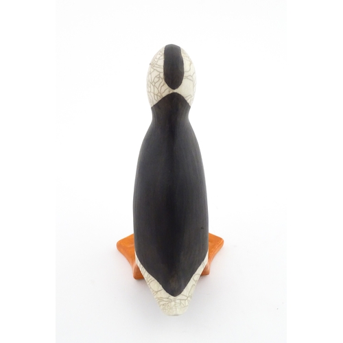 90 - A studio pottery raku fired model of a puffin by Tony White. Marked under. Approx. 9 3/4