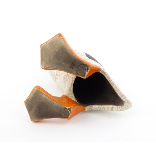 90 - A studio pottery raku fired model of a puffin by Tony White. Marked under. Approx. 9 3/4