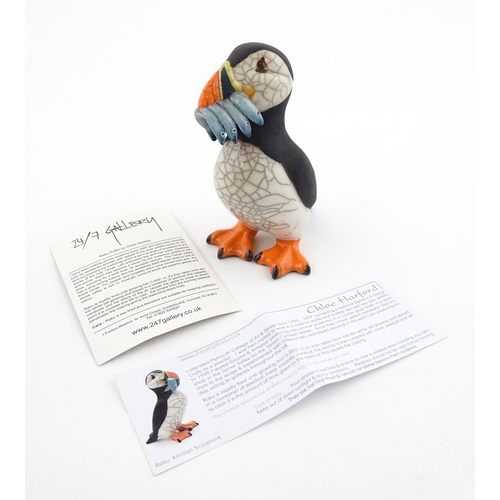 91 - A studio pottery raku fired model of a puffin by Chloe Harford. Marked under. Approx. 6 3/4