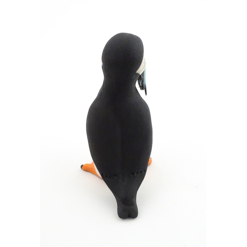 91 - A studio pottery raku fired model of a puffin by Chloe Harford. Marked under. Approx. 6 3/4