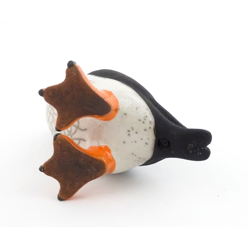 91 - A studio pottery raku fired model of a puffin by Chloe Harford. Marked under. Approx. 6 3/4