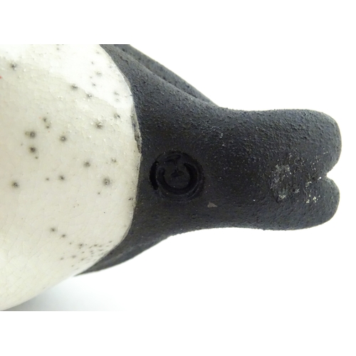 91 - A studio pottery raku fired model of a puffin by Chloe Harford. Marked under. Approx. 6 3/4