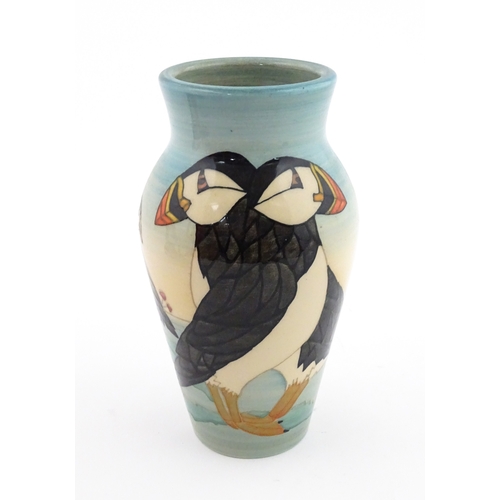 92 - A Dennis China Works vase with puffin detail. Marked under no. 14 / 100. Approx. 8