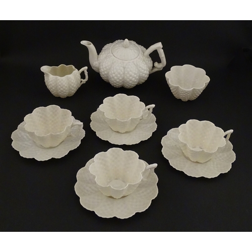 72 - A Belleek tea set in the Cone pattern, comprising teapot, milk jug, sugar bowl and four cups and sau... 