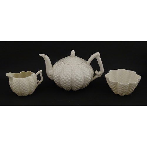 72 - A Belleek tea set in the Cone pattern, comprising teapot, milk jug, sugar bowl and four cups and sau... 