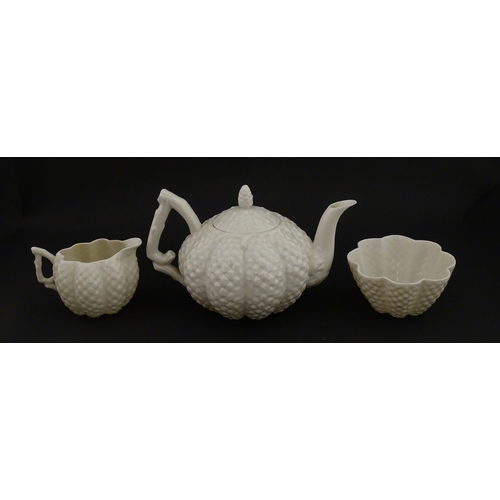 72 - A Belleek tea set in the Cone pattern, comprising teapot, milk jug, sugar bowl and four cups and sau... 