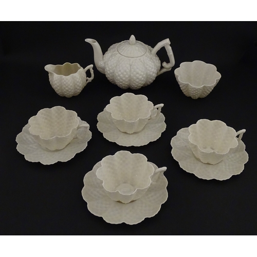 72 - A Belleek tea set in the Cone pattern, comprising teapot, milk jug, sugar bowl and four cups and sau... 