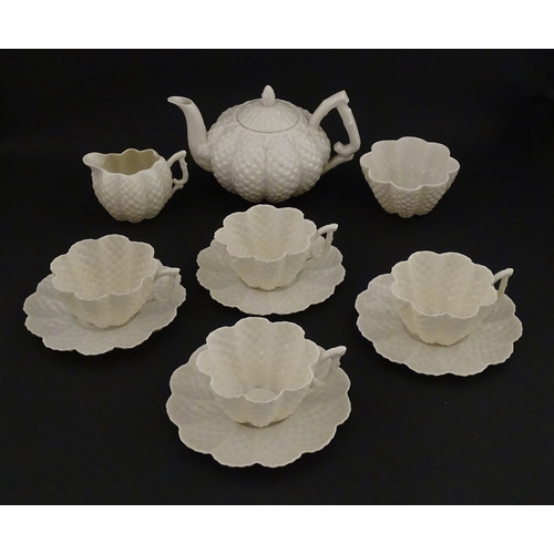 72 - A Belleek tea set in the Cone pattern, comprising teapot, milk jug, sugar bowl and four cups and sau... 