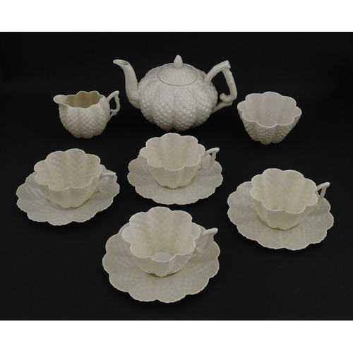 72 - A Belleek tea set in the Cone pattern, comprising teapot, milk jug, sugar bowl and four cups and sau... 