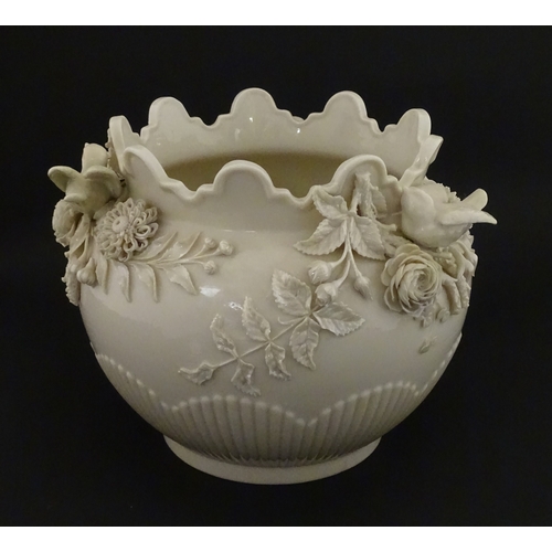 66 - A Belleek Rathmore jardiniere / planter decorated with birds, flowers and foliage. Marked with Secon... 