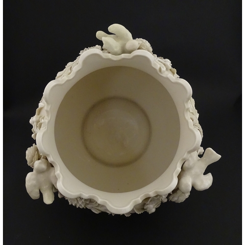 66 - A Belleek Rathmore jardiniere / planter decorated with birds, flowers and foliage. Marked with Secon... 