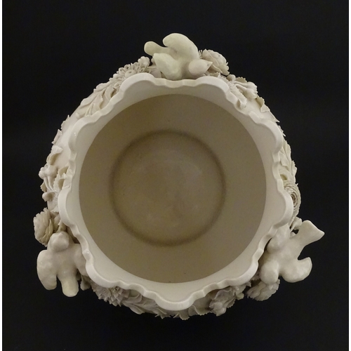 66 - A Belleek Rathmore jardiniere / planter decorated with birds, flowers and foliage. Marked with Secon... 