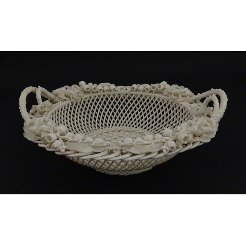 67 - A Belleek three strand Lily Basket having lattice work with ribbon edges, decorated with lily of the... 