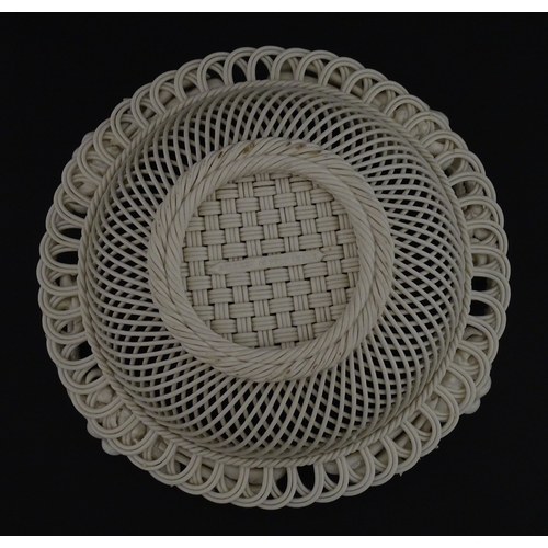 67 - A Belleek three strand Lily Basket having lattice work with ribbon edges, decorated with lily of the... 