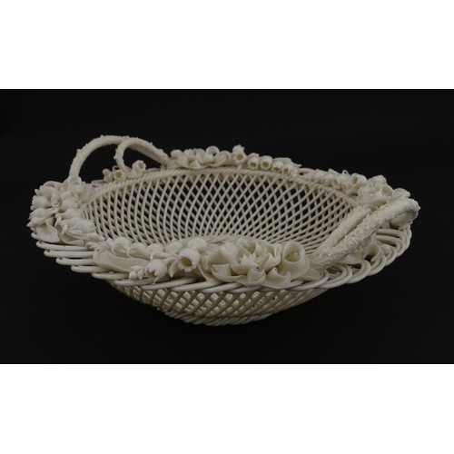 67 - A Belleek three strand Lily Basket having lattice work with ribbon edges, decorated with lily of the... 