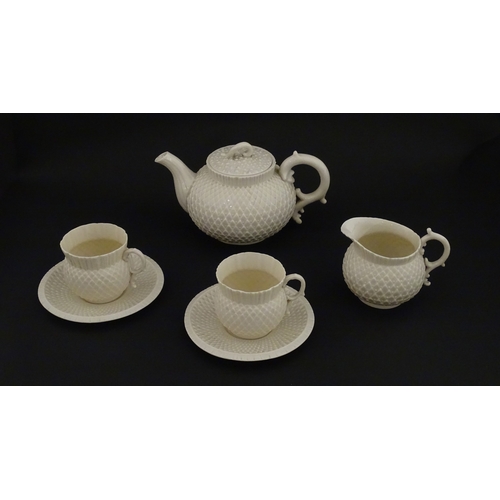 68 - Belleek tea wares in the Thistle pattern comprising teapot, milk jug and two cups and saucers. Marke... 