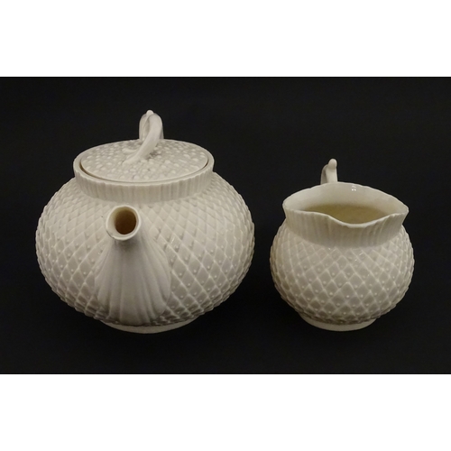 68 - Belleek tea wares in the Thistle pattern comprising teapot, milk jug and two cups and saucers. Marke... 