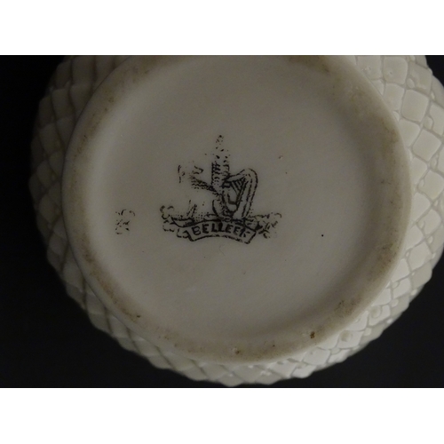 68 - Belleek tea wares in the Thistle pattern comprising teapot, milk jug and two cups and saucers. Marke... 