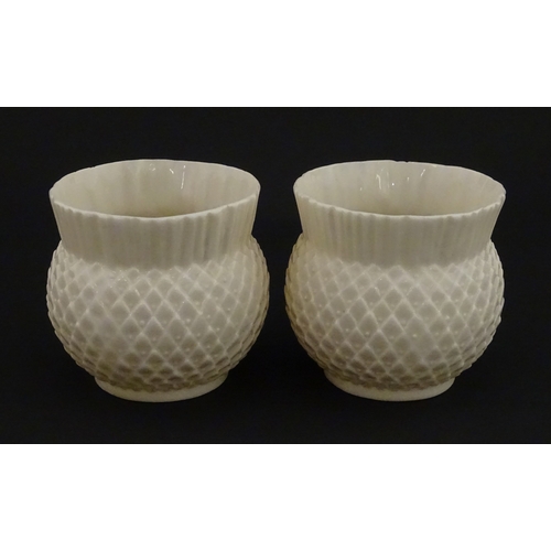 68 - Belleek tea wares in the Thistle pattern comprising teapot, milk jug and two cups and saucers. Marke... 