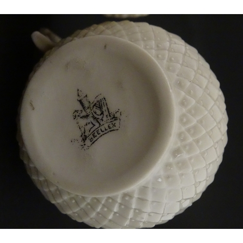 68 - Belleek tea wares in the Thistle pattern comprising teapot, milk jug and two cups and saucers. Marke... 