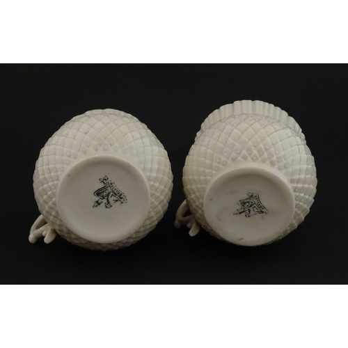 68 - Belleek tea wares in the Thistle pattern comprising teapot, milk jug and two cups and saucers. Marke... 