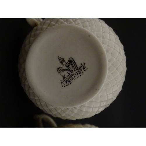 68 - Belleek tea wares in the Thistle pattern comprising teapot, milk jug and two cups and saucers. Marke... 