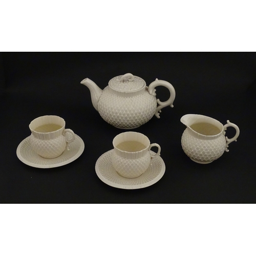 68 - Belleek tea wares in the Thistle pattern comprising teapot, milk jug and two cups and saucers. Marke... 