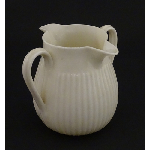 70 - A Belleek Lifford pattern double spout cream jug with twin handles. Marked with Second Period mark u... 