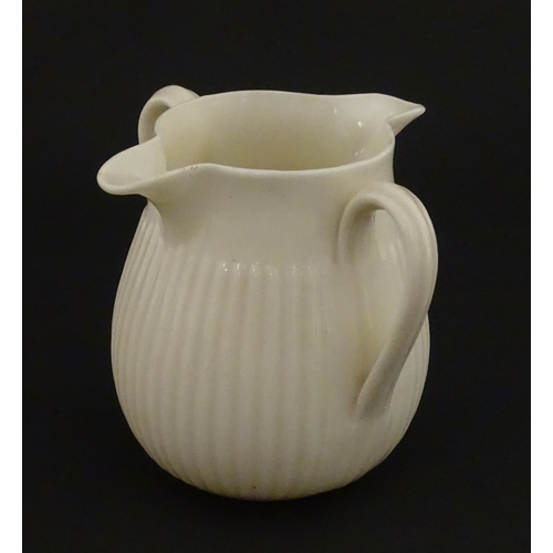 70 - A Belleek Lifford pattern double spout cream jug with twin handles. Marked with Second Period mark u... 